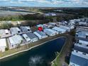 An aerial view of mobile homes in a vibrant community surrounding a picturesque lake with a fountain at 222 N Saint George Cir, Apollo Beach, FL 33572