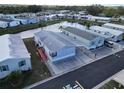 Beautiful aerial view of charming mobile homes in a lakeside community with mature trees and manicured lawns at 222 N Saint George Cir, Apollo Beach, FL 33572