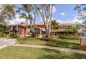 Beautiful two-story home with well-manicured lawn, mature trees, and a welcoming facade at 2965 Eagle Estates E Cir, Clearwater, FL 33761