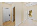 Bright foyer with beautiful tile flooring, neutral wall color, and a view to the outside at 4006 N 27Th St, Tampa, FL 33610