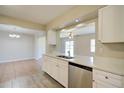 Bright kitchen with white cabinets, stainless steel appliances, and breakfast bar at 5043 Escalante Dr, North Port, FL 34287