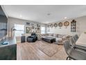 Inviting living room featuring wood floors, modern decor, a comfortable sectional couch, and great natural light at 5351 Bridge St # 81, Tampa, FL 33611