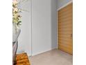 Hallway with tile floors and a modern door at 1020 Sunset Point Rd # 703, Clearwater, FL 33755