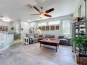 Living room view features tile floors, recessed lighting, and a large sectional sofa at 1219 Huntington Greens Dr, Sun City Center, FL 33573