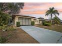 Charming single-story home with landscaped front yard, long driveway and inviting entryway at 12503 Willow Tree Ave, Hudson, FL 34669