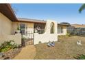 Close up of entryway with a low fence and gate leading to the front door at 12503 Willow Tree Ave, Hudson, FL 34669