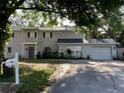 Two-story home with an attached garage and brick accents, set on a landscaped lot at 14803 Tulip Dr, Tampa, FL 33613