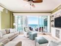 Comfortable living room featuring plush seating, built-in shelving, and stunning ocean views through large glass doors at 1590 Gulf Blvd # 501, Clearwater Beach, FL 33767