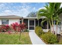 Inviting screened entry porch, complemented by vibrant landscaping, offering a serene welcome at 1782 Coconut Dr, Venice, FL 34293