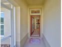 Welcoming entryway leads into a bright, open home with a glimpse of the kitchen at 1912 Acadia Greens Dr, Sun City Center, FL 33573