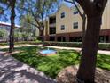 Serene courtyard featuring a decorative fountain and manicured landscaping, adding to the complex's charm at 2010 E Palm Ave # 14206, Tampa, FL 33605