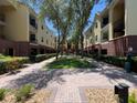 Exterior view of the community showcasing the buildings, courtyard and well-manicured landscaping at 2010 E Palm Ave # 14206, Tampa, FL 33605