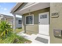 Charming home entrance with a secure white door, green exterior and manicured landscaping at 2851 16Th N Ave, St Petersburg, FL 33713