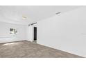 Spacious living room featuring tile floor, window, and sliding barn door at 2851 16Th N Ave, St Petersburg, FL 33713