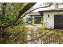 A bright home exterior with black trim, drought-tolerant landscaping, and easy to see street numbers at 29318 Whipporwill Ln, Wesley Chapel, FL 33543