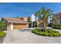 Beautiful exterior view with a private driveway, an attached garage and a luscious palm tree at 4900 59Th S Ave, St Petersburg, FL 33715