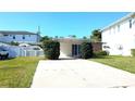 Charming single-story home featuring a well-maintained lawn and convenient carport at 602 Danube Ave, Tampa, FL 33606