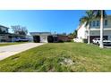 Well-manicured front lawn and appealing single-story house with a carport at 602 Danube Ave, Tampa, FL 33606