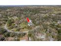 Aerial view of the property showcasing its private setting with mature trees and surrounding landscape at 6615 Ridge Top Dr, Trinity, FL 34655