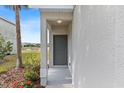 Inviting front door with a covered porch and landscaped flower bed at 7086 Chatum Light Run, Bradenton, FL 34212