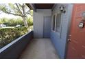Condo entrance featuring a gray painted exterior and an orange front door with a Masterlock at 10263 Gandy N Blvd # 105, St Petersburg, FL 33702
