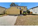 Charming two-story home with attached garage and well-maintained lawn, sunny day at 10403 Frog Pond Dr, Riverview, FL 33569