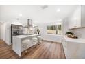 Bright kitchen featuring stainless steel appliances, white cabinetry, and a large center island with seating at 1125 Fairwood Ave, Clearwater, FL 33759