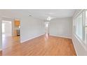 Bright living room features gleaming hardwood floors and large windows at 1140 7Th Ne Ave, Largo, FL 33770