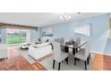 Bright living room features modern decor, large windows, and stylish dining area at 204 Mary Dr, Oldsmar, FL 34677