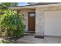 Inviting front entrance with a wood door and manicured landscaping at 2084 Whitney Dr, Clearwater, FL 33760