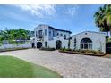 Beautiful white home with a spacious brick driveway and well-maintained landscaping at 2113 S West Shore Blvd, Tampa, FL 33629