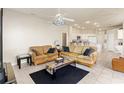 Bright living room with tile flooring that flows into an open-concept kitchen with ample natural light at 2250 Long View Cir, Brooksville, FL 34604