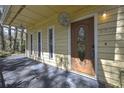 Inviting front porch featuring a decorative front door and ample space for seating at 2602 Fiddlestick Cir, Lutz, FL 33559