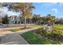 Scenic view of the neighborhood street with sidewalks, landscaping and a Longleaf Veterans Field sign at 3622 Wiregrass Rd, New Port Richey, FL 34655