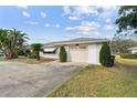 Single story home with an attached two car garage and mature landscaping at 1730 Sunset Point Rd, Clearwater, FL 33755