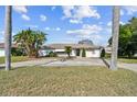 Single story home with mature landscaping and a spacious driveway at 1730 Sunset Point Rd, Clearwater, FL 33755