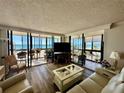 Relax in this light and bright living room with floor to ceiling windows and patio access at 18304 Gulf Blvd # 217, Redington Shores, FL 33708