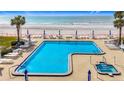 Enjoy a spacious community pool with Gulf views, tables, chairs, umbrellas and a hot tub at 18304 Gulf Blvd # 217, Redington Shores, FL 33708