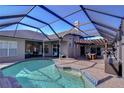 Beautiful screened-in pool with a pergola-covered patio and outdoor dining area for relaxation and entertaining at 2902 Winding Trail Dr, Valrico, FL 33596