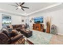 Spacious living room with coffered ceilings and tile flooring at 32231 Conchshell Sail St, Wesley Chapel, FL 33545