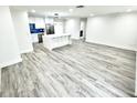 Spacious open-concept living area with wood flooring, and recessed lighting adjacent to the modern kitchen at 3735 69Th N Way, St Petersburg, FL 33710