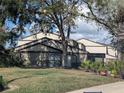 Exterior view of a well-maintained two-story home with tidy landscaping and healthy green grass at 375 Woods Landing Trl, Oldsmar, FL 34677