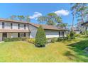 Charming two-story home with manicured lawn and mature landscaping at 5434 Saddlebrook Way # 3, Wesley Chapel, FL 33543