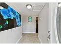 Neutral hallway with lovely flooring, decor, and views to the exterior at 7701 Jackson Spring Rd, Tampa, FL 33615