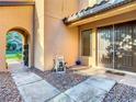 Welcoming covered front porch with double doors, tiled floors, decorative rock, and an arched entry at 8264 Dunham Station Dr, Tampa, FL 33647