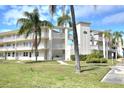 Charming condo building featuring multiple floors, balconies, and well-maintained landscaping at 960 Virginia St # 205, Dunedin, FL 34698