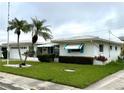 Beautiful home featuring a well-maintained lawn, vibrant landscaping, and a charming exterior design at 10063 40Th N St # 3, Pinellas Park, FL 33782