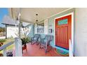 Charming front porch with rocking chairs and a bright red front door at 1011 W Charter St, Tampa, FL 33602