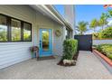 Charming front entrance with a light blue door, decorative wreath, and well-maintained landscaping at 10351 Longwood Dr, Seminole, FL 33777