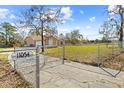 Spacious front yard featuring a gated entrance and expansive green space at 11054 Liberto Rd, Weeki Wachee, FL 34614